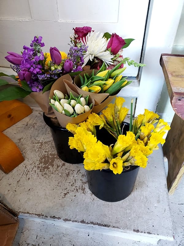 Two buckets with daffodils and grab and go bouquets.