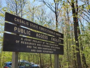 A wooden sign for Casalis State Forest noting Public Access Facility that reads 'A joint project of the department of resources and economic development, and the New Hampshire Fish and Game Department'