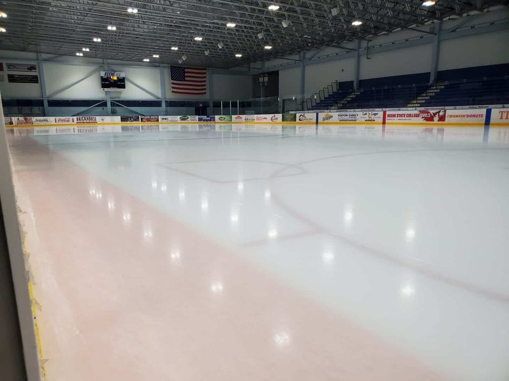 A smooth ice rink in an indoor arenna