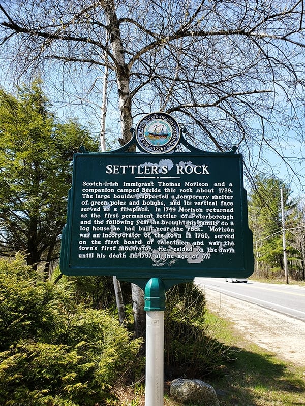 Green historic marker sign for Settler's Rock